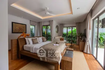Luxurious bedroom with modern decor and garden view, featuring elegant wooden furniture and soft lighting.