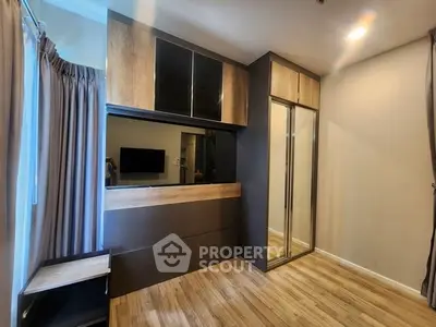 Modern bedroom with sleek built-in wardrobe and wooden flooring