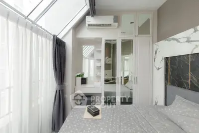 Modern bedroom with stylish decor, large windows, and air conditioning unit.