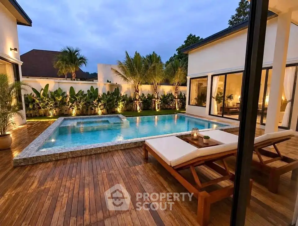 Luxurious modern home with stunning pool and elegant outdoor lounge area.