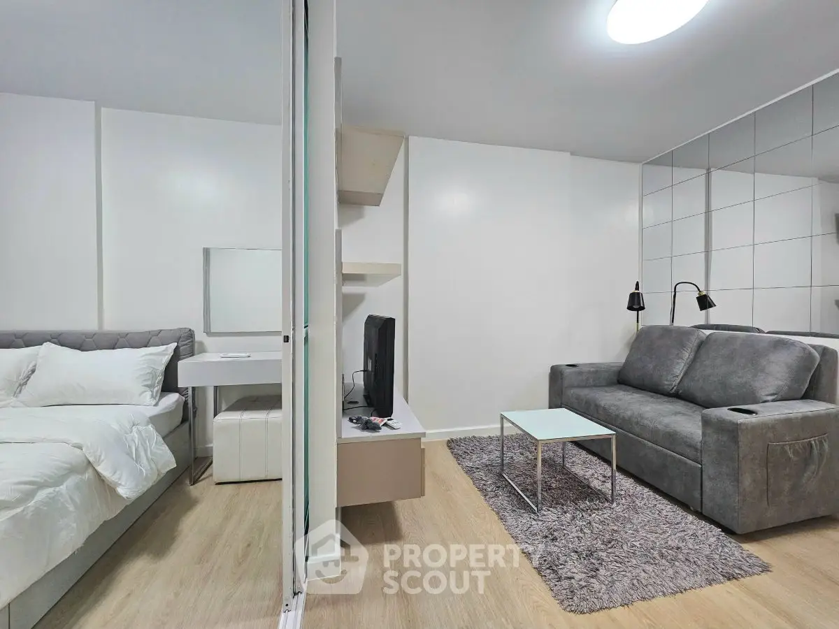 Modern studio apartment with cozy living area and stylish bedroom