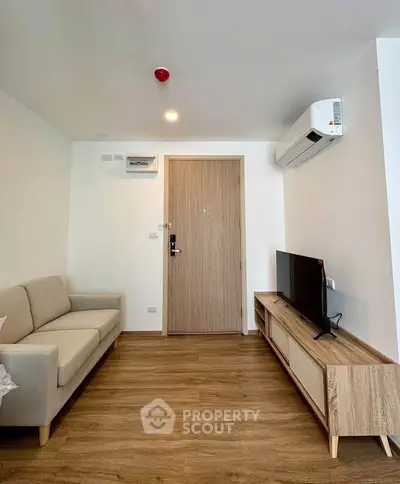 Modern living room with sleek furniture and air conditioning in a stylish apartment.