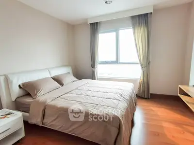 Spacious bedroom with large window and elegant curtains in modern apartment