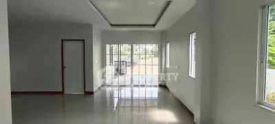 Spacious empty living room with large windows and glossy floor