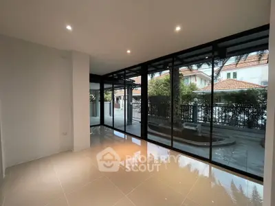 Modern living room with large windows and garden view