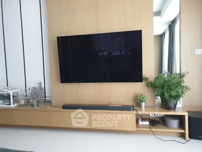 Modern living room with sleek wall-mounted TV and stylish decor