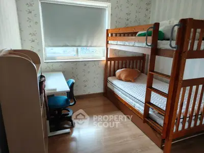 Cozy bedroom with bunk beds and study desk, perfect for kids or guests.