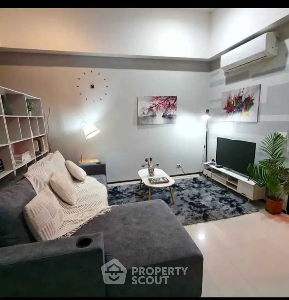 Modern living room with stylish decor and cozy seating area.