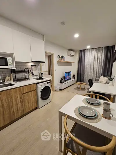 Modern open-plan kitchen and living room with stylish decor and appliances.