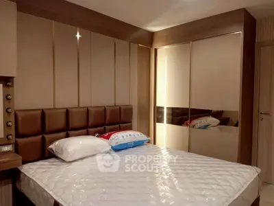 Modern bedroom with stylish headboard and mirrored wardrobe