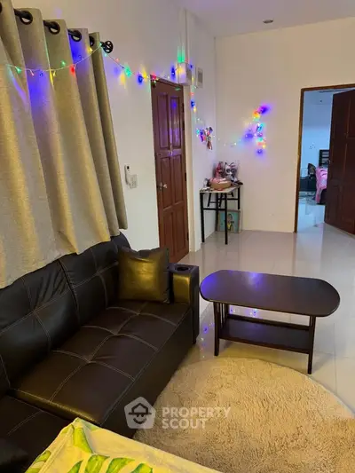 Cozy living room with festive lights and modern furniture