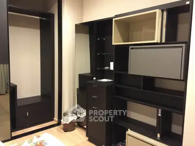 Modern walk-in closet with sleek black shelving and ample storage space.