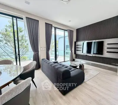 Modern living room with sleek design, large windows, and stylish furniture, perfect for contemporary living.