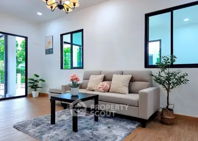 Modern living room with stylish decor and large windows for natural light.