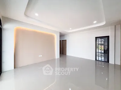 Spacious modern living room with sleek tile flooring and ambient lighting