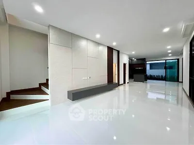 Spacious modern living room with sleek design and ample natural light.