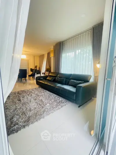 Spacious living room with elegant decor and large windows for natural light