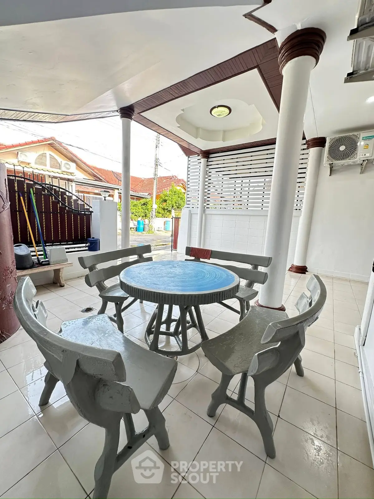 Charming outdoor patio with round table and chairs, perfect for relaxation and gatherings.