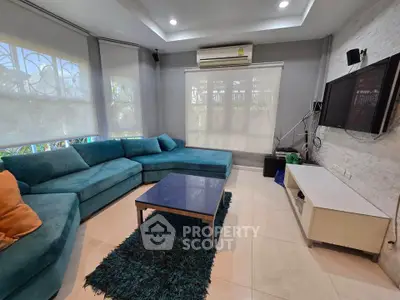 Spacious living room with modern decor and large windows for natural light.