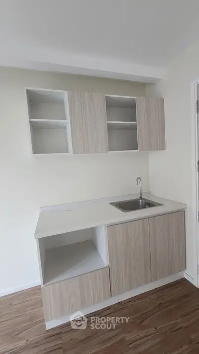 Modern minimalist kitchen with sleek cabinetry and stainless steel sink