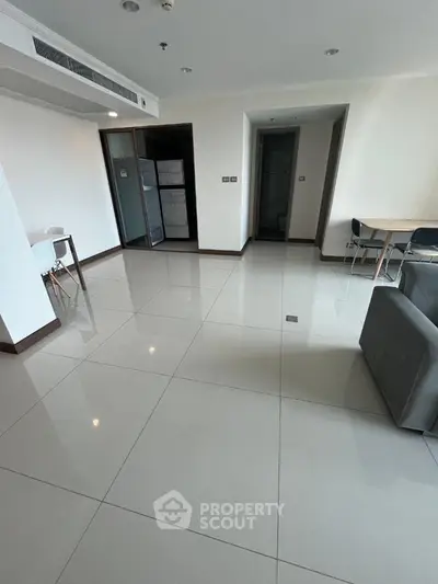 Spacious modern living room with sleek tile flooring and minimalist furniture