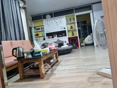 Spacious living room with modern decor and wooden flooring