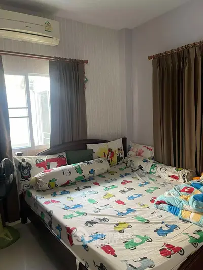 Cozy bedroom with colorful bedding and natural light