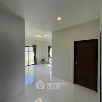 Spacious modern living room with large windows and elegant lighting