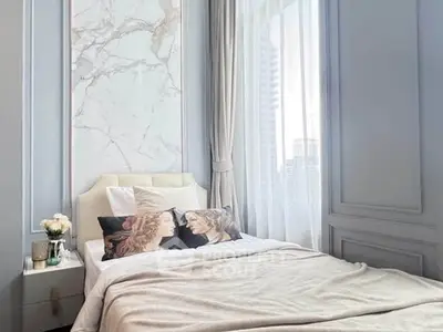 Luxurious bedroom with elegant decor and city view, featuring a plush bed and stylish accents.