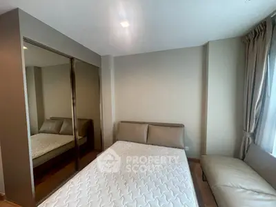 Modern bedroom with mirrored closet and cozy bed in a stylish apartment