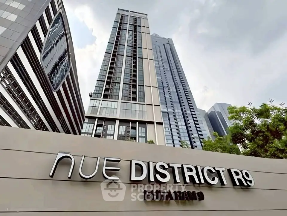 Modern high-rise building with sleek design at Nue District R9, Phra Ram 9.