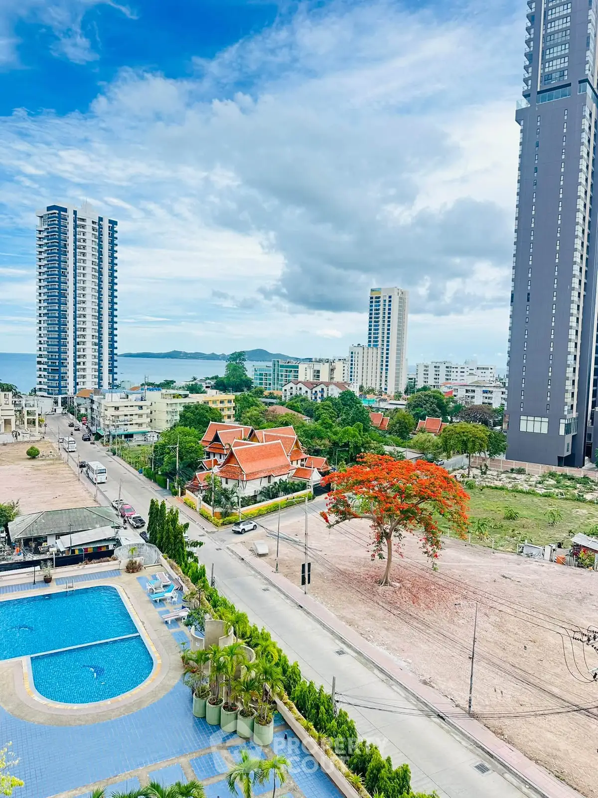 Stunning cityscape view with modern high-rise buildings and a refreshing pool, perfect for urban living.