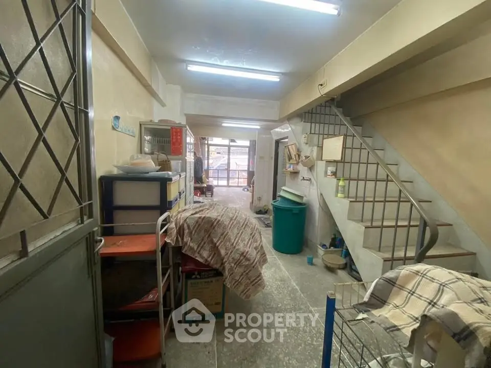 Spacious interior with staircase and storage potential in a versatile real estate property.