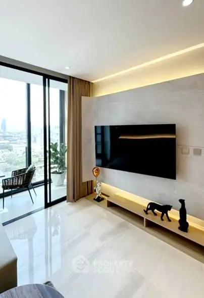Modern living room with large TV and balcony view in luxury apartment