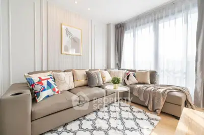 Bright and stylish living room with modern decor and large windows.