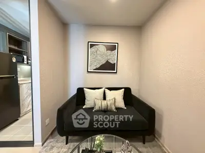 Cozy living room with modern black sofa and stylish wall art