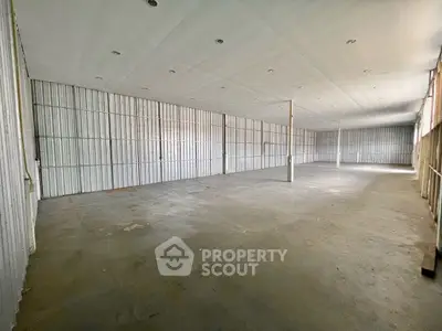 Spacious industrial warehouse with high ceilings and ample storage space.