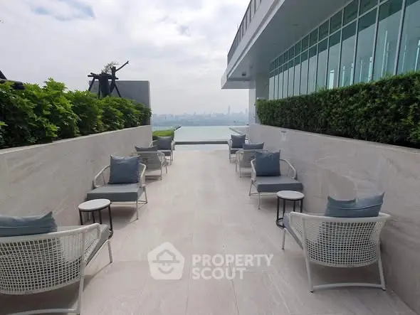 Luxurious rooftop terrace with stunning city view and modern seating area.