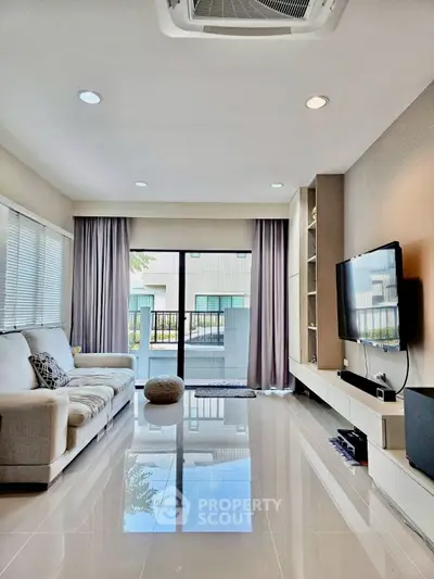 Modern living room with sleek design, large windows, and stylish furniture.
