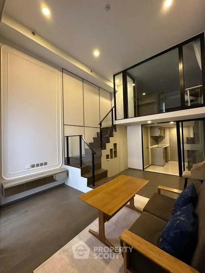 Modern duplex living room with stylish staircase and open kitchen layout