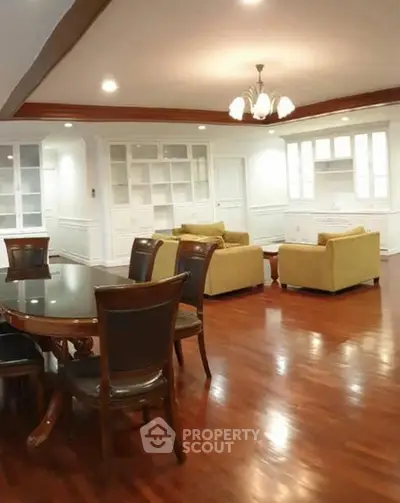 Spacious living room with elegant wooden flooring and stylish furniture