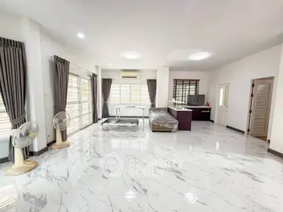 Spacious modern living room with marble flooring and natural light