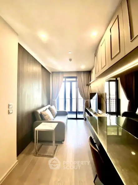 Modern living room with sleek furniture and large windows for natural light.