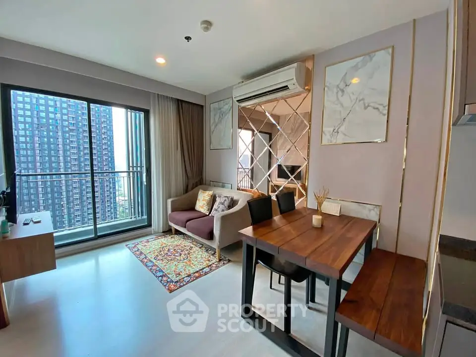 Modern living room with balcony view in high-rise apartment, featuring stylish decor and ample natural light.