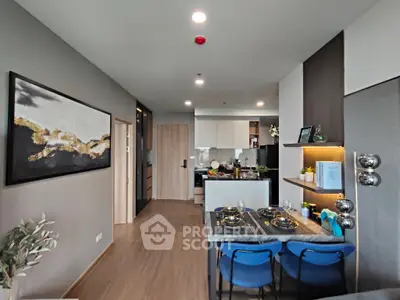 Modern open-layout kitchen and dining area with stylish decor and wooden flooring.