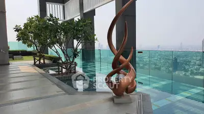 Luxurious rooftop pool with stunning city views and modern sculpture, perfect for relaxation and entertainment.