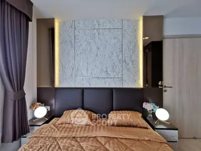Luxurious bedroom with elegant marble accent wall and ambient lighting