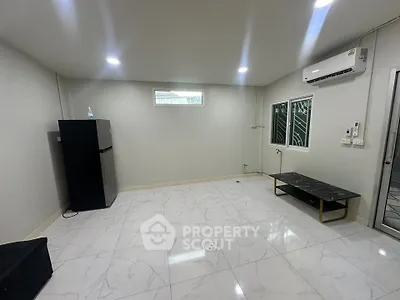 Spacious modern room with sleek marble flooring and air conditioning, ideal for versatile living arrangements.