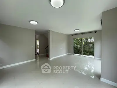 Spacious modern living room with large windows and garden view