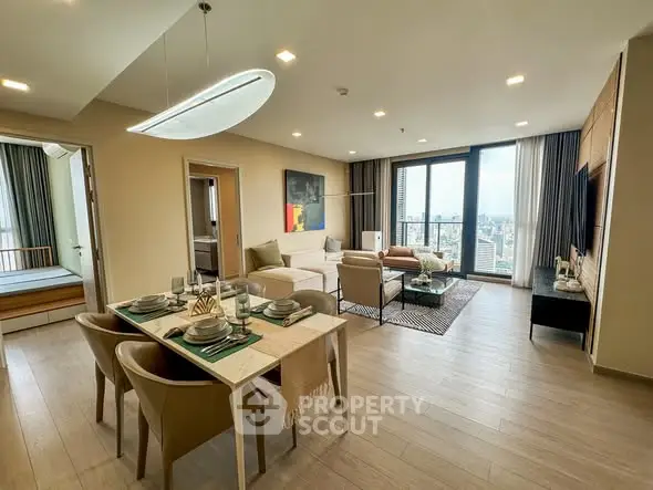 Spacious modern living room with dining area and city view balcony.